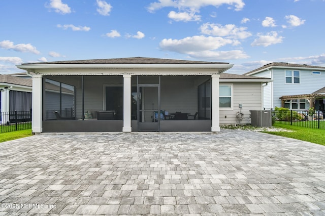 back of house with a sunroom, central AC, and fence