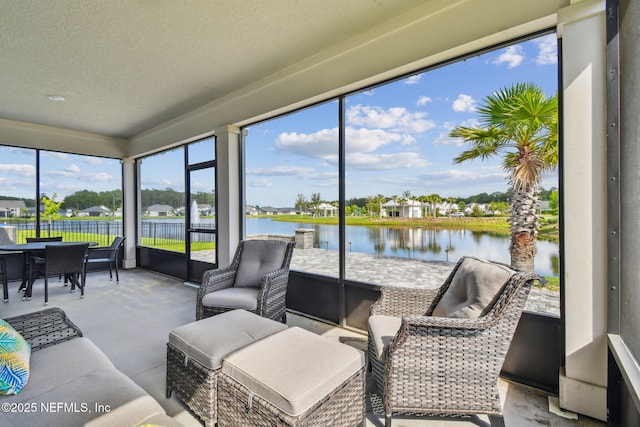 sunroom / solarium with a water view