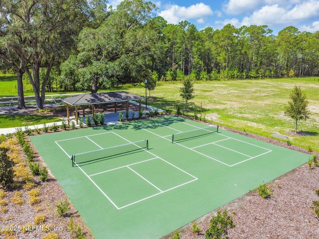 view of tennis court with fence and a gazebo