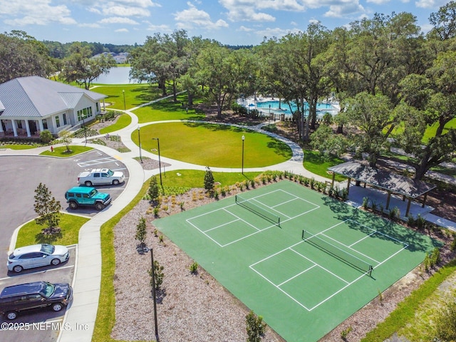 aerial view of a pool area and a large body of water