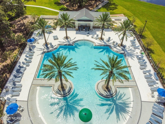 community pool with a patio and a yard