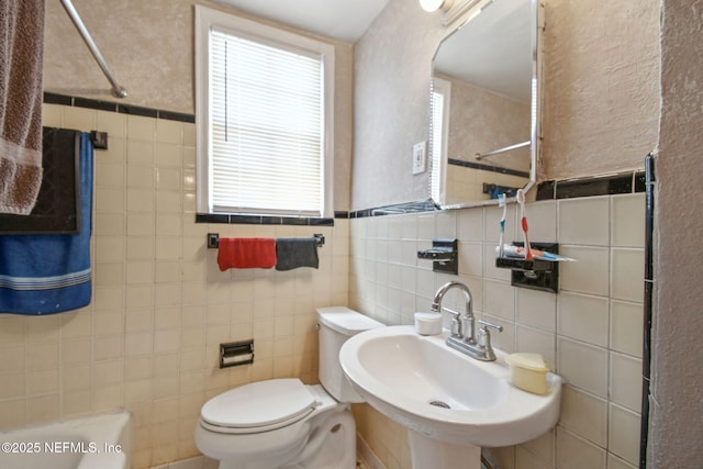 2660 Gale Ct, Jacksonville, FL 32204 - bathroom with tile walls, a sink, healthy amount of natural light, toilet, and a shower