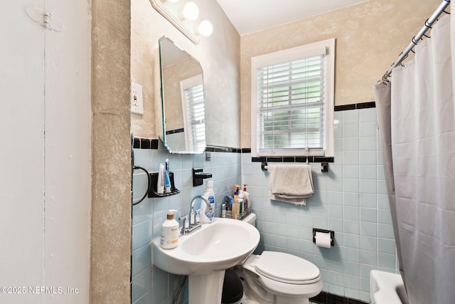 2660 Gale Ct, Jacksonville, FL 32204 - bathroom featuring tile walls, toilet, a sink, water heater, and a wainscoted wall