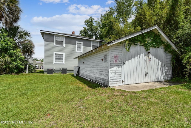 2660 Gale Ct, Jacksonville, FL 32204 - back of house featuring a yard, an outbuilding, and cooling unit