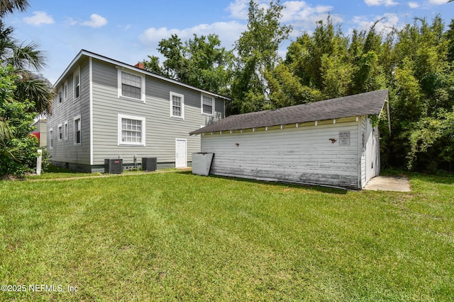 2660 Gale Ct, Jacksonville, FL 32204 - back of house featuring central AC unit, a lawn, an outdoor structure, and a chimney