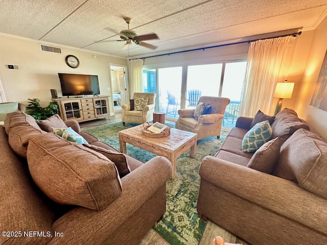 3240 Fletcher Ave Unit 665, Fernandina Beach, FL 32034 - living room featuring a ceiling fan, a textured ceiling, and ornamental molding