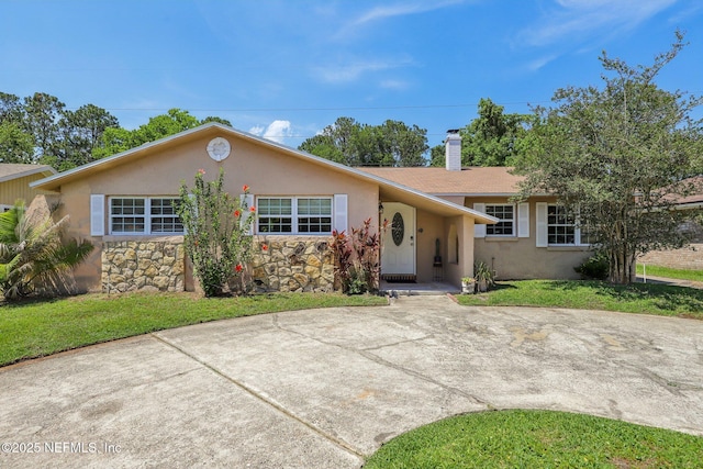 4033 Lazy Hollow Ln N, Jacksonville, FL 32257 - single story home featuring stucco siding, stone siding, a chimney, and a front lawn