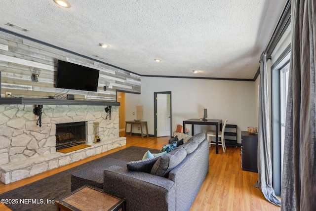 4033 Lazy Hollow Ln N, Jacksonville, FL 32257 - living area featuring a textured ceiling, crown molding, wood finished floors, and a stone fireplace