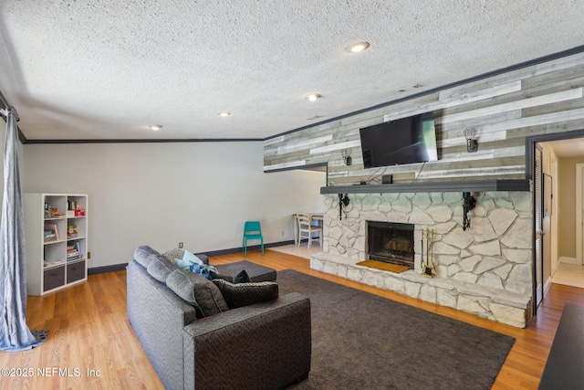 4033 Lazy Hollow Ln N, Jacksonville, FL 32257 - living room featuring baseboards, wood finished floors, a textured ceiling, ornamental molding, and a stone fireplace