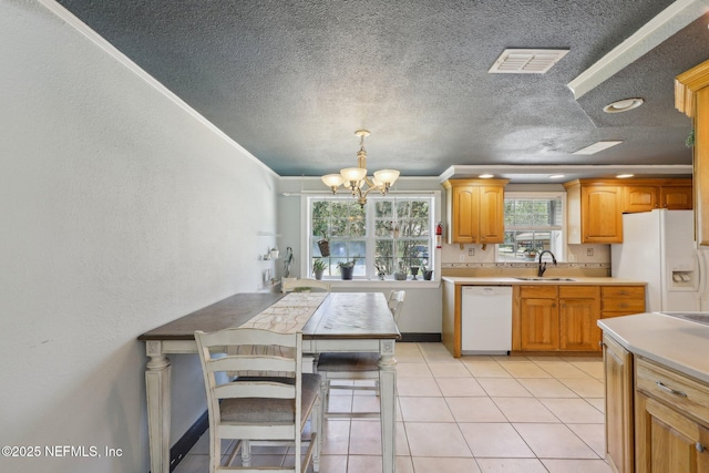 4033 Lazy Hollow Ln N, Jacksonville, FL 32257 - kitchen with white appliances, a sink, a chandelier, light countertops, and a textured ceiling