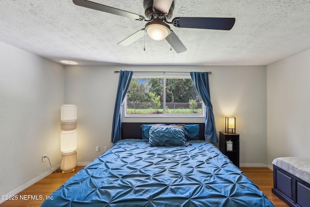 4033 Lazy Hollow Ln N, Jacksonville, FL 32257 - bedroom featuring wood finished floors, a ceiling fan, baseboards, and a textured ceiling