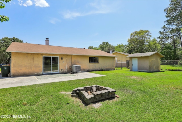 4033 Lazy Hollow Ln N, Jacksonville, FL 32257 - rear view of property featuring central AC unit, a fire pit, a patio, a chimney, and stucco siding