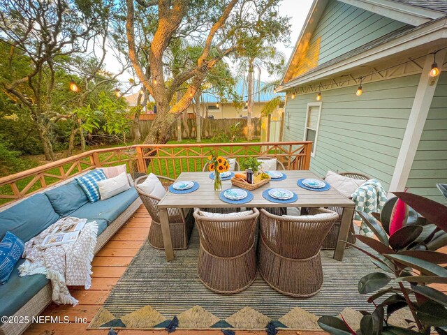 deck with outdoor lounge area and outdoor dining space