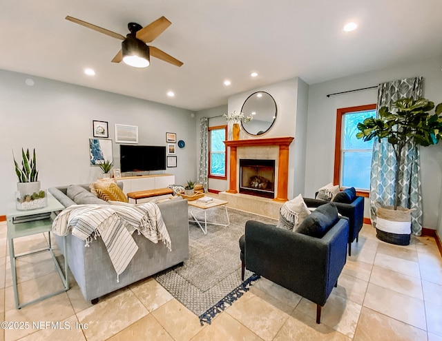 living area featuring plenty of natural light, a fireplace, recessed lighting, ceiling fan, and light tile patterned flooring