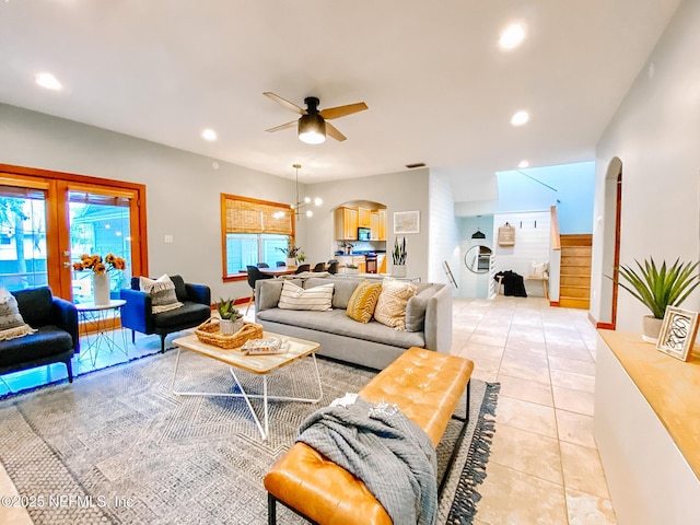 living area with arched walkways, ceiling fan, light tile patterned flooring, recessed lighting, and french doors