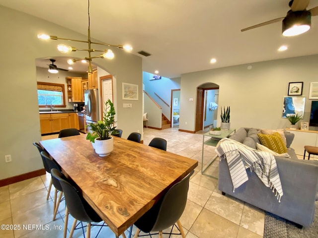 dining space with ceiling fan, arched walkways, stairs, light tile patterned floors, and recessed lighting
