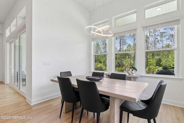 355 Caiden Dr, Ponte Vedra, FL 32081 - dining room featuring a chandelier, light wood-style flooring, and baseboards
