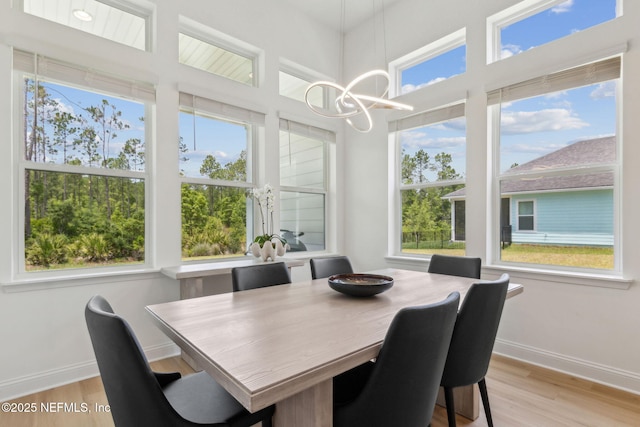 355 Caiden Dr, Ponte Vedra, FL 32081 - dining space with a chandelier, light wood-type flooring, plenty of natural light, and baseboards