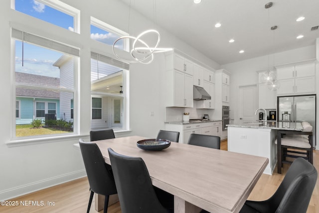 355 Caiden Dr, Ponte Vedra, FL 32081 - dining room with a chandelier, light wood finished floors, recessed lighting, and baseboards