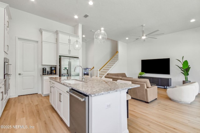 355 Caiden Dr, Ponte Vedra, FL 32081 - kitchen featuring appliances with stainless steel finishes, a sink, light wood finished floors, an island with sink, and recessed lighting