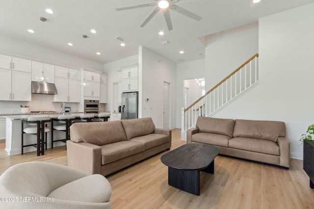 355 Caiden Dr, Ponte Vedra, FL 32081 - living room with stairs, light wood-style floors, a ceiling fan, recessed lighting, and baseboards