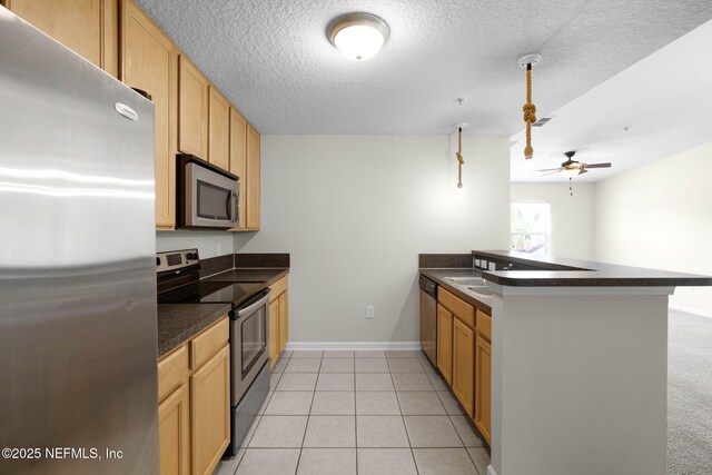 13856 Herons Landing Way Unit 11-7, Jacksonville, FL 32224 - kitchen with appliances with stainless steel finishes, dark countertops, a peninsula, ceiling fan, and baseboards