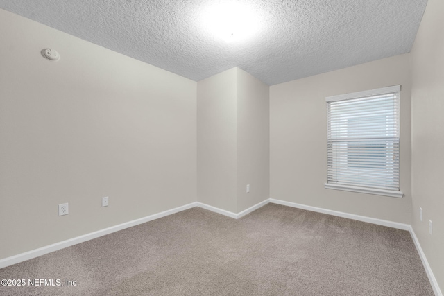 13856 Herons Landing Way Unit 11-7, Jacksonville, FL 32224 - spare room with a textured ceiling, carpet floors, baseboards, and a smoke detector