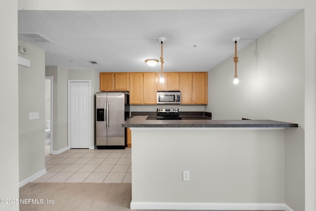 13856 Herons Landing Way Unit 11-7, Jacksonville, FL 32224 - kitchen featuring appliances with stainless steel finishes, dark countertops, light tile patterned floors, hanging light fixtures, and light colored carpet