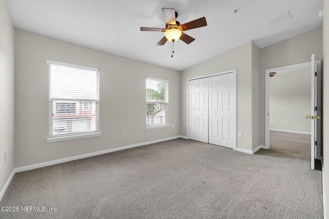 13856 Herons Landing Way Unit 11-7, Jacksonville, FL 32224 - unfurnished bedroom with carpet floors, baseboards, a closet, lofted ceiling, and a ceiling fan