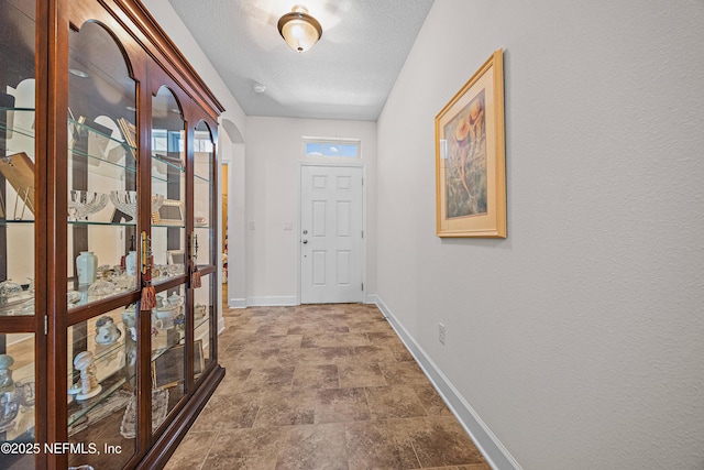 285 Yearling Blvd, Saint Johns, FL 32259 - hallway featuring baseboards, a textured ceiling, and stone finish flooring