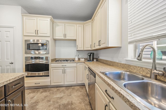 285 Yearling Blvd, Saint Johns, FL 32259 - kitchen featuring appliances with stainless steel finishes, a sink, light countertops, cream cabinets, and dark brown cabinetry