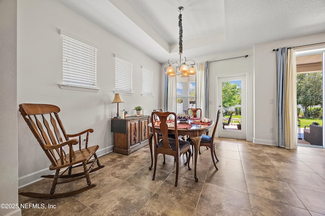 285 Yearling Blvd, Saint Johns, FL 32259 - dining room with a chandelier, a raised ceiling, baseboards, and a textured ceiling