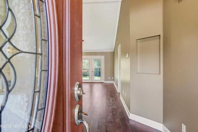 hallway with ornamental molding, baseboards, and dark wood-style floors