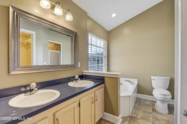 bathroom featuring toilet, a garden tub, baseboards, double vanity, and a shower with shower door