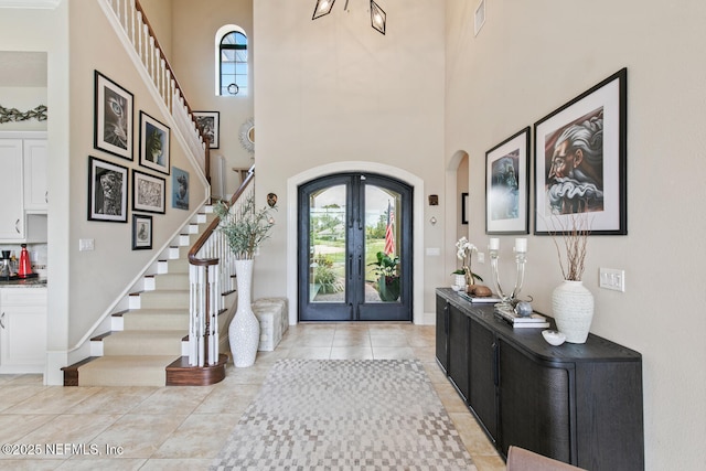 110 Heron Dr, Palm Coast, FL 32137 - foyer entrance with a towering ceiling, plenty of natural light, french doors, and stairway