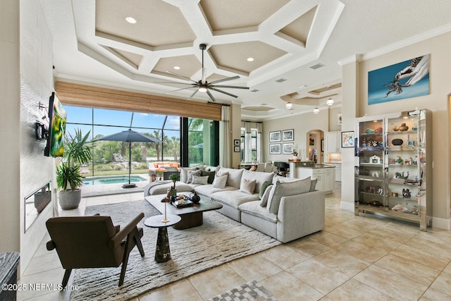 110 Heron Dr, Palm Coast, FL 32137 - living room featuring coffered ceiling, arched walkways, crown molding, a ceiling fan, and light tile patterned floors