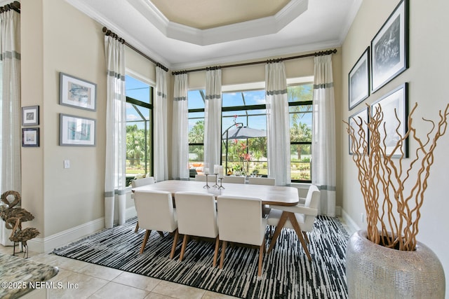 110 Heron Dr, Palm Coast, FL 32137 - tiled dining area with ornamental molding, healthy amount of natural light, baseboards, and a tray ceiling
