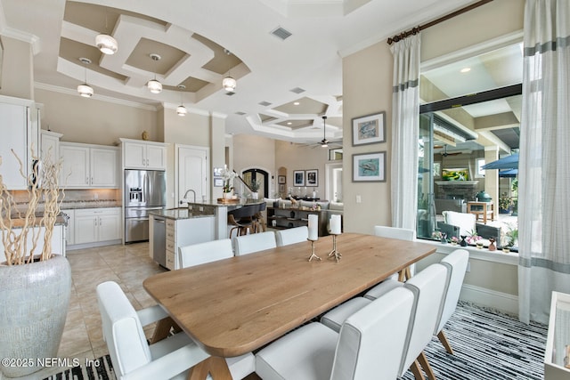 110 Heron Dr, Palm Coast, FL 32137 - dining room with coffered ceiling, ceiling fan, crown molding, a high ceiling, and light tile patterned flooring