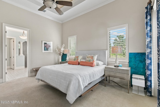110 Heron Dr, Palm Coast, FL 32137 - carpeted bedroom featuring ornamental molding, multiple windows, ceiling fan, and ensuite bathroom