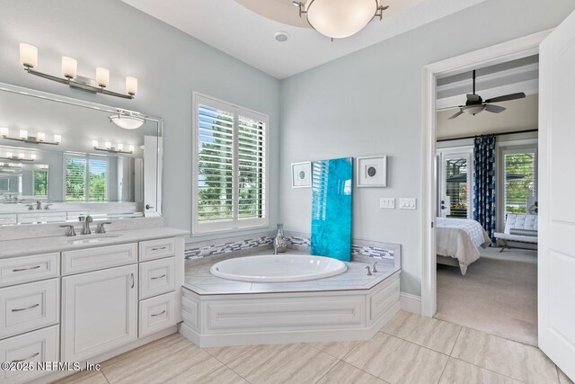 110 Heron Dr, Palm Coast, FL 32137 - ensuite bathroom featuring healthy amount of natural light, a bath, and vanity