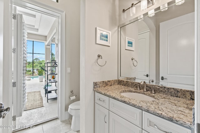 110 Heron Dr, Palm Coast, FL 32137 - bathroom with toilet, vanity, tile patterned floors, and baseboards