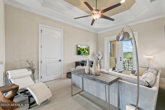 110 Heron Dr, Palm Coast, FL 32137 - living area featuring a raised ceiling, a ceiling fan, crown molding, light colored carpet, and baseboards