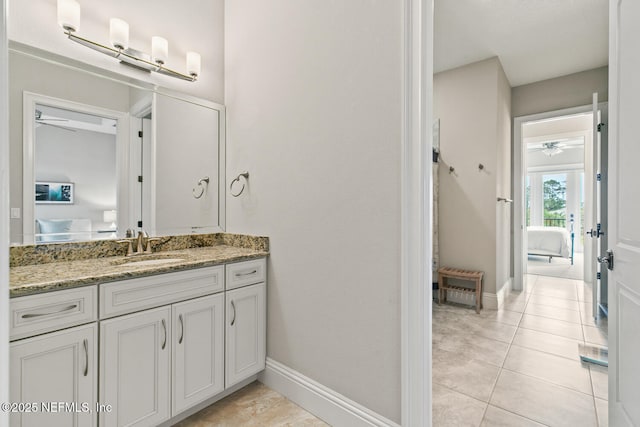 110 Heron Dr, Palm Coast, FL 32137 - bathroom with a ceiling fan, tile patterned flooring, baseboards, and vanity