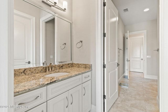 110 Heron Dr, Palm Coast, FL 32137 - bathroom featuring vanity, baseboards, and tile patterned flooring