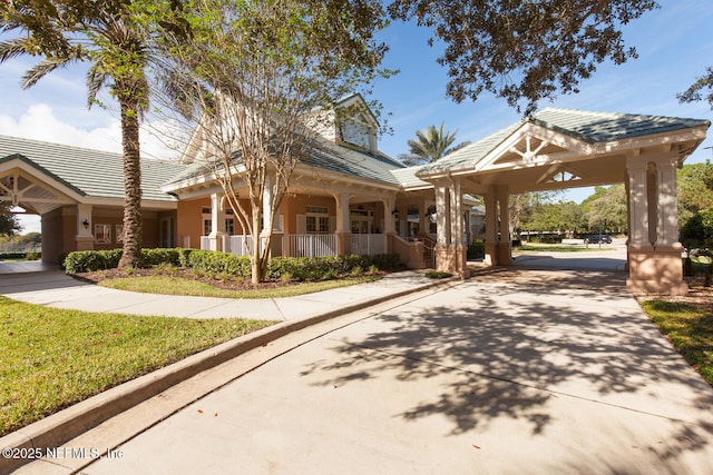 110 Heron Dr, Palm Coast, FL 32137 - view of front facade featuring covered porch, stucco siding, concrete driveway, and a tile roof