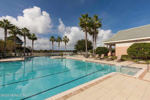 110 Heron Dr, Palm Coast, FL 32137 - community pool featuring a patio and fence