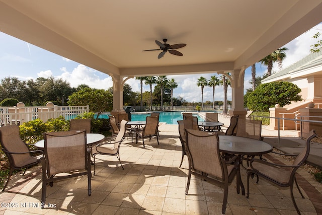 110 Heron Dr, Palm Coast, FL 32137 - view of patio / terrace with outdoor dining area, an outdoor pool, a ceiling fan, and fence