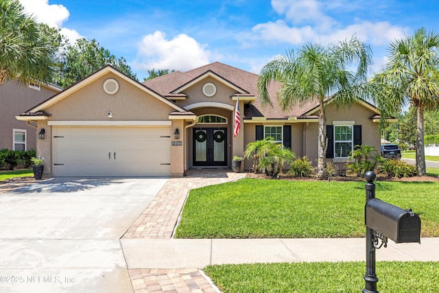 217 Willow Winds Pkwy, Saint Johns, FL 32259 - ranch-style house featuring french doors, stucco siding, a garage, a front lawn, and driveway