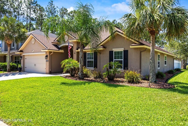 217 Willow Winds Pkwy, Saint Johns, FL 32259 - ranch-style home with stucco siding, a garage, a front yard, and driveway
