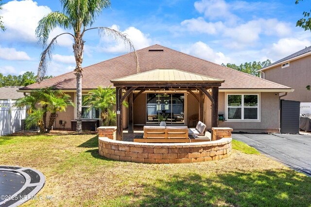 217 Willow Winds Pkwy, Saint Johns, FL 32259 - back of property with a gazebo, a patio, a shingled roof, and stucco siding